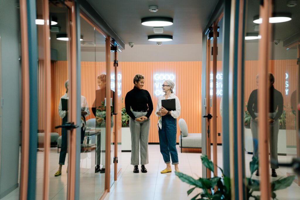 Two colleagues walking through a modern technology office