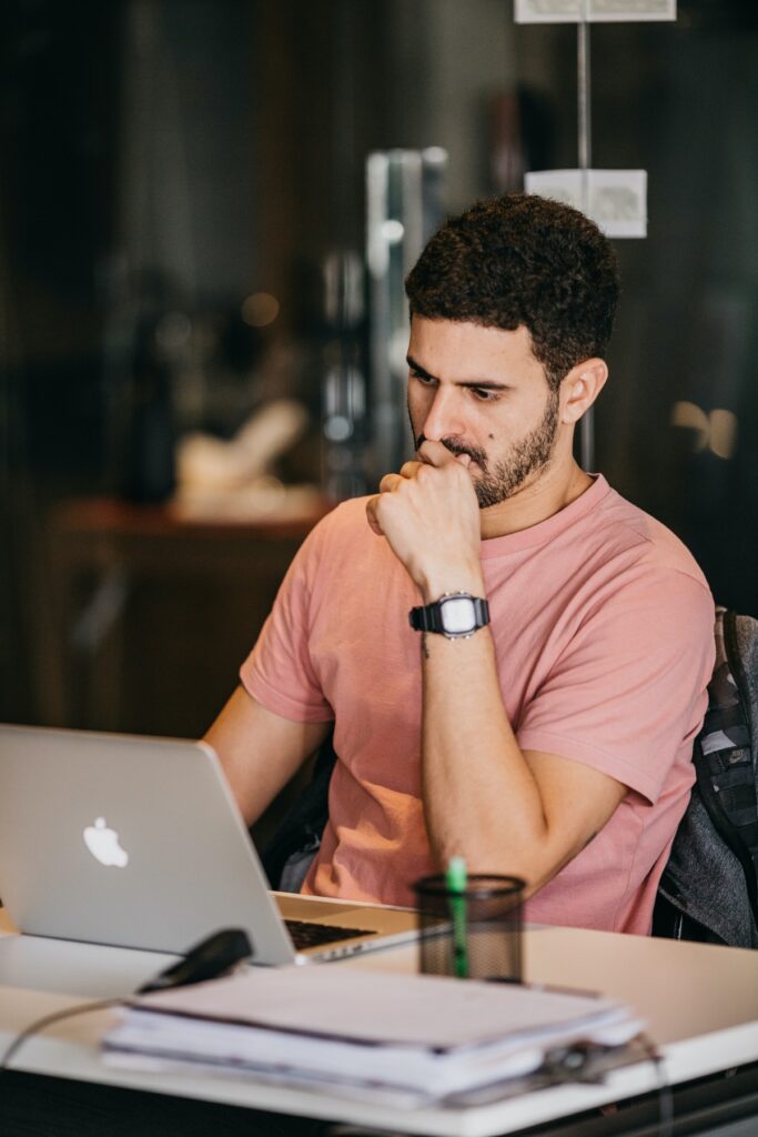 Software engineer concentrating while working on a laptop